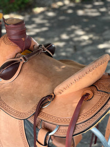 16" 58 Wade saddle with chocolate suede seat, antique finish, and berry conchos for a unique appearance.