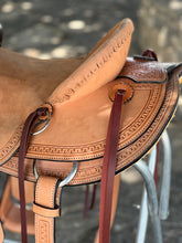 Load image into Gallery viewer, 16&quot; 58 Wade saddle with Wyoming and basket tooling, leather stirrups, and a 6-3/4&quot; gullet for comfort.