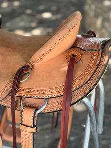 16" 58 Wade saddle with Wyoming and basket tooling, leather stirrups, and a 6-3/4" gullet for comfort.