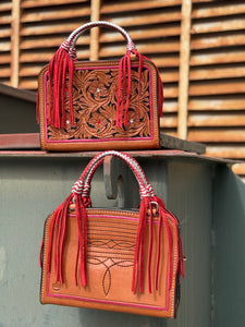 The Leave Him on Red Bronco Bag features metallic red and silver braided handles with card slot.