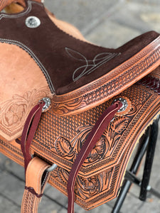 Durable Ranchy Roper Saddle with leather roughout floral tooling, nylon tie straps, and breastcollar dees.