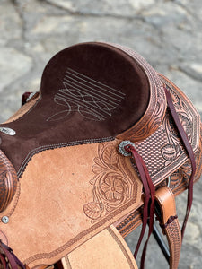 Ranchy Roper Saddle with A-17 PTM tree, full padded seat, and chain border tooling for ultimate comfort.