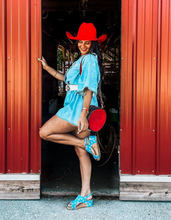 Load image into Gallery viewer, Handcrafted Cowboy Stitch Canteen Bag in red with floral and geometric tooling, removable strap, and Buckstitch accents.