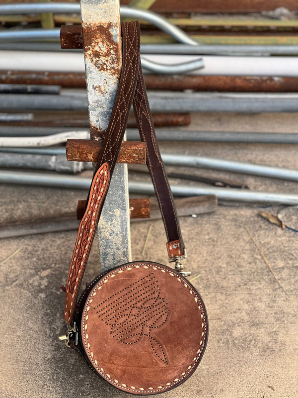 The Cowboy Stitch Canteen Bag in chocolate with floral tooling, removable strap, and Buckstitch details.