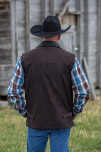 Durable Oilskin Concealed Carry Vest in waxed canvas, water-resistant with hidden holsters and adjustable straps for comfort.