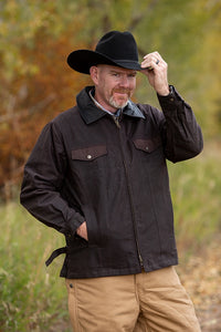 Oilskin Concealed Carry Jacket made from waxed canvas with leather collar, hidden holsters, and magazine holders.