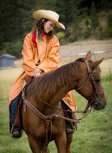 The Pommel Fish Slicker is waterproof, made with acrylic latex-coated muslin, and features sealed stitching and a calf-length hem to keep you dry on the trail.